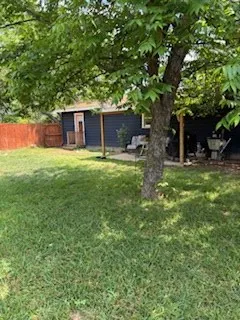 a backyard of a house with table and chairs