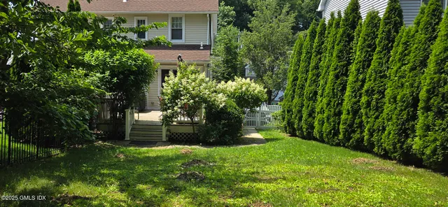 a view of entryway with wooden floor and windows