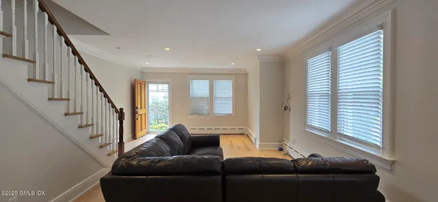 a view of a house with a tree in front of it