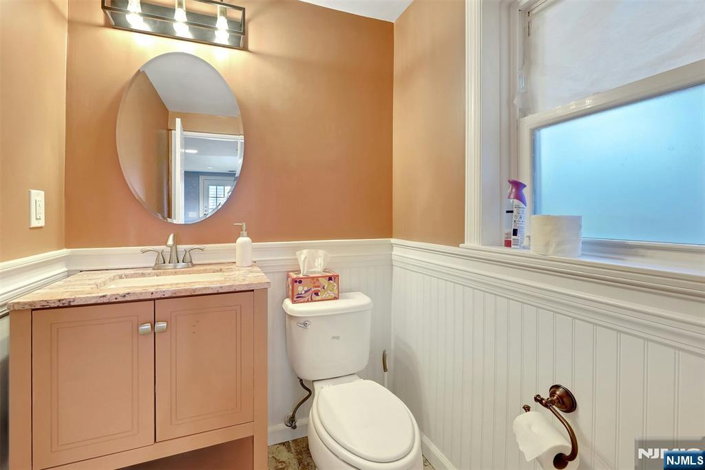 514 Rutland Avenue Teaneck, NJ 07666 - Photo 26 of 40 a bathroom with a granite countertop toilet sink and mirror