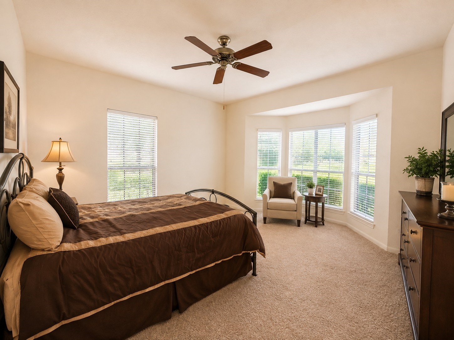 5518 Lacreek Lane Spring, TX 77379 - Photo 15 of 29 PRIMARY BEDROOM - Alternate view highlights the spacious primary retreat with a charming bay-window sitting area, abundant natural light, a ceiling fan, and plenty of room to create a relaxing seating or reading space.
