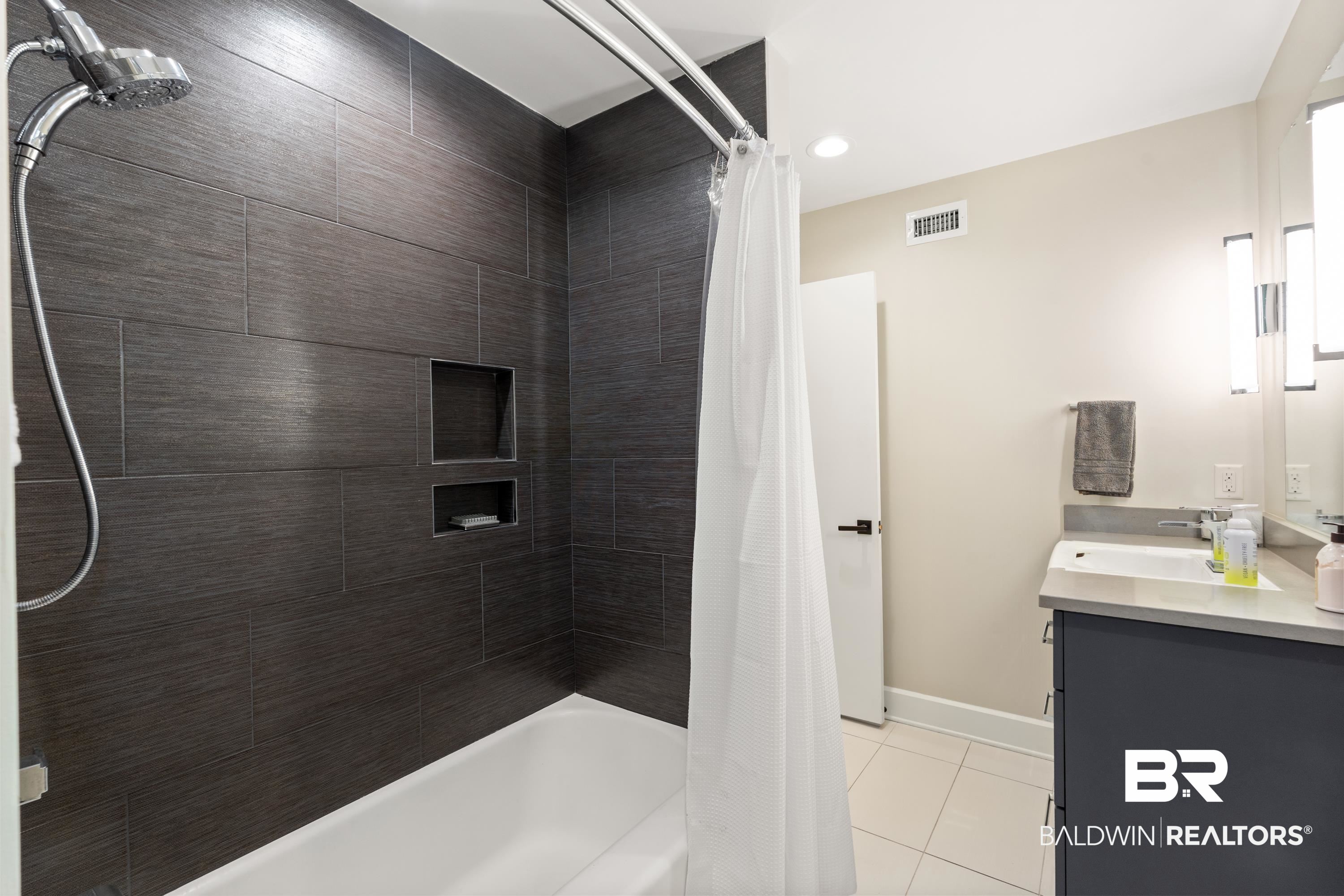 233 Suzanne Circle Mobile, AL 36608 - Photo 32 of 85 Bathroom featuring shower / bathtub combination with curtain, double vanity, light tile patterned floors, and recessed lighting