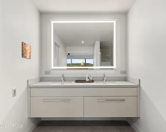 a bedroom with two beds and a large window