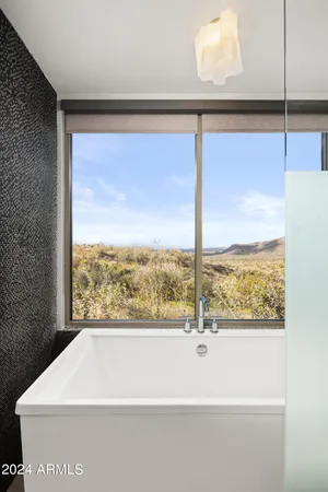 a bedroom with a large bed and a large window