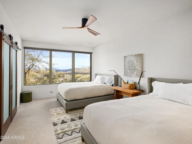 a bedroom with a bed and a painting on the wall