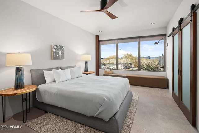 a bedroom with a large bed and a large window