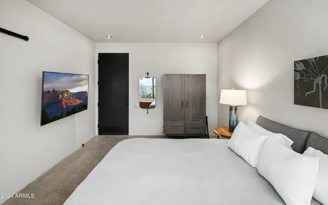 a bathroom with a double vanity sink a mirror and a toilet