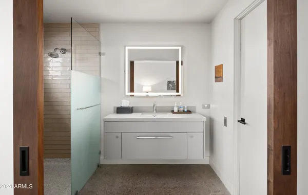 a bathroom with a granite countertop bathtub shower sink and toilet