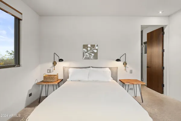 a bedroom with a large bed and a window