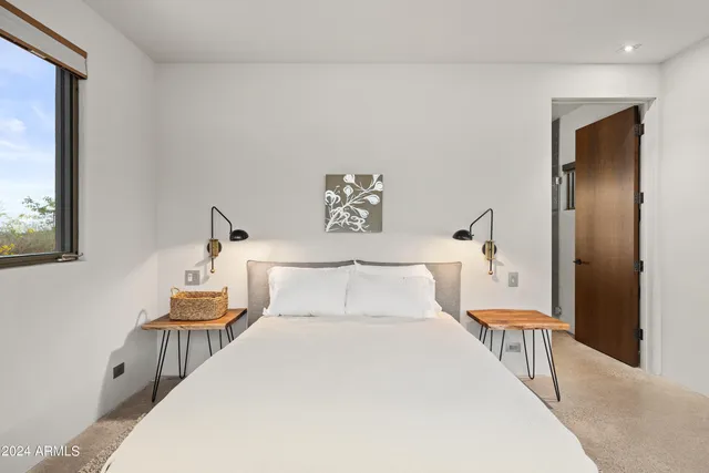 a bedroom with a large bed and a window