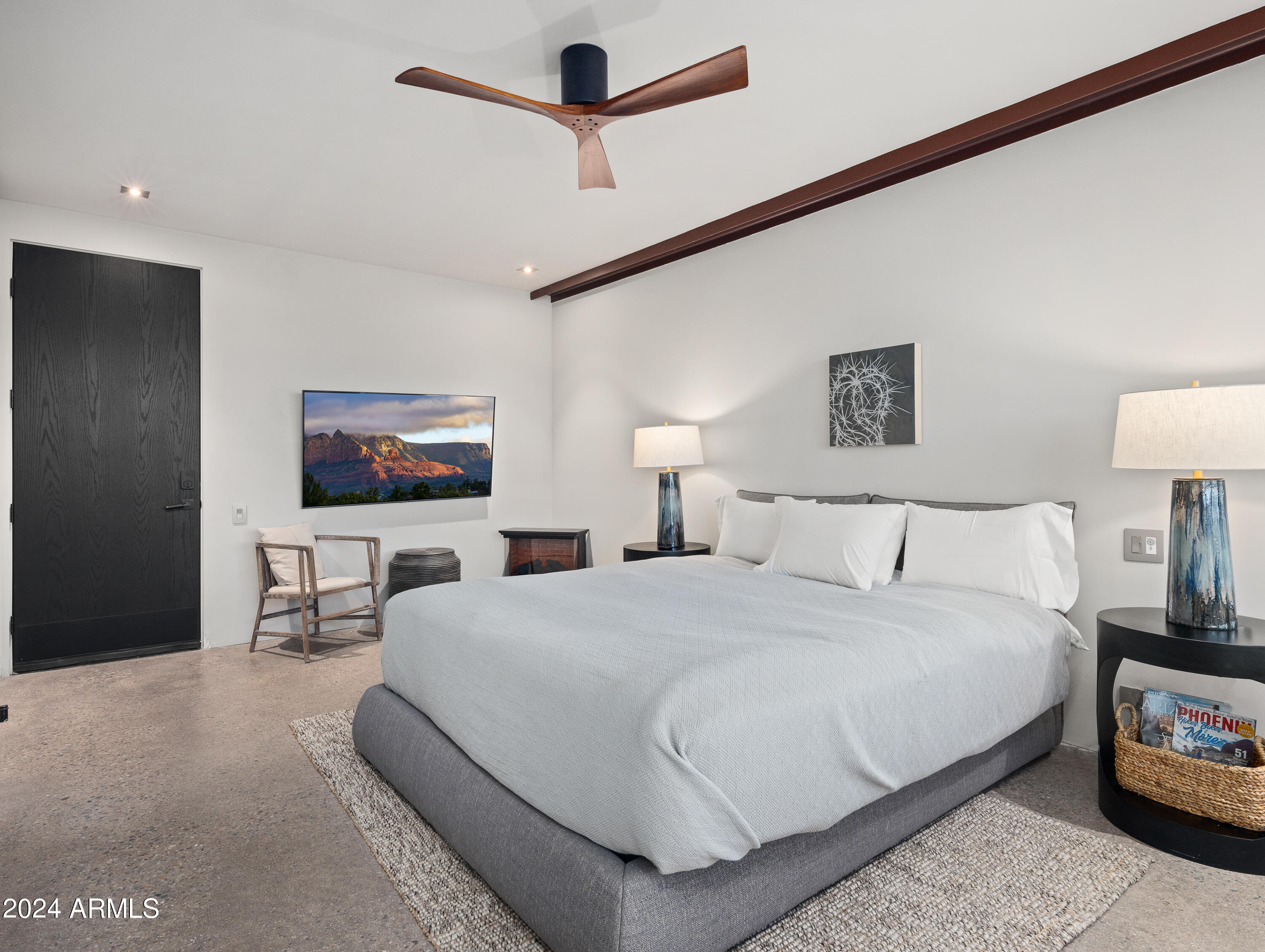 15310 North Sandy Bluff Road Fort McDowell, AZ 85264 - Photo 32 of 58 a bedroom with a bed a lamp on the wall and a flat screen tv