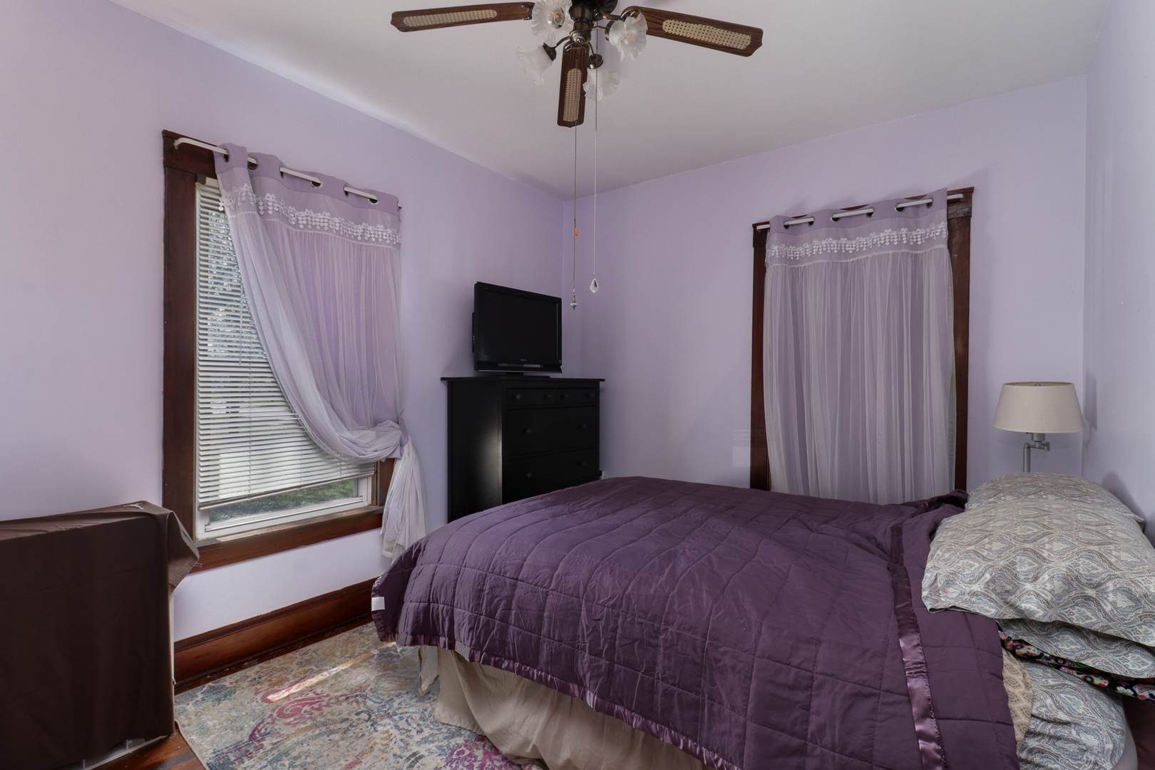 706 Vale Street Bloomington, IL 61701 - Photo 20 of 46 a bedroom with a bed a dresser and a chandelier