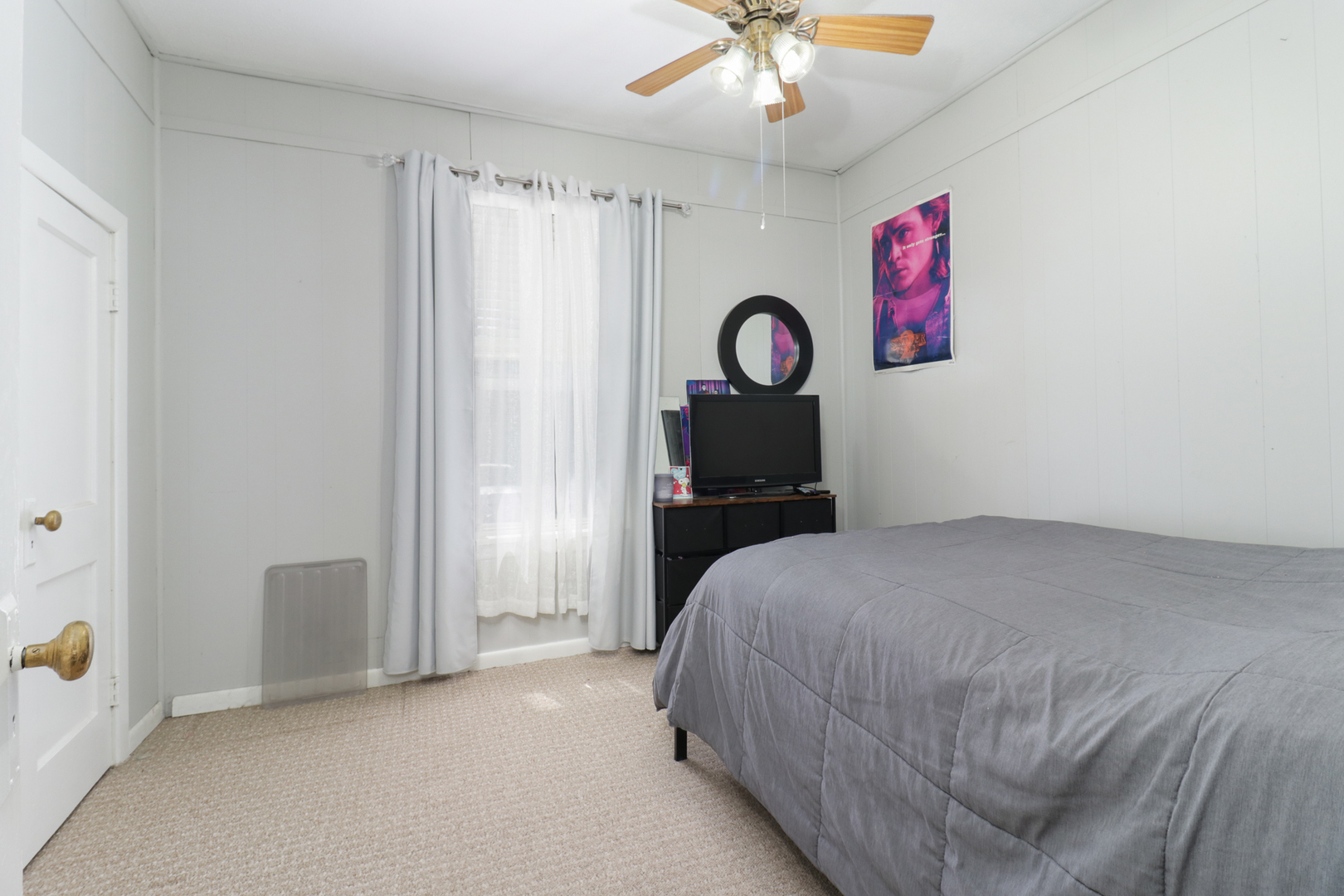 706 Vale Street Bloomington, IL 61701 - Photo 10 of 46 a bedroom with a bed and a chandelier