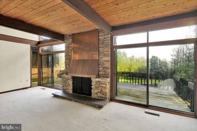 a view of staircase with lots of frames on wall and windows