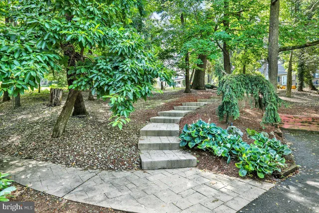 a view of a room with wooden floor and iron stairs