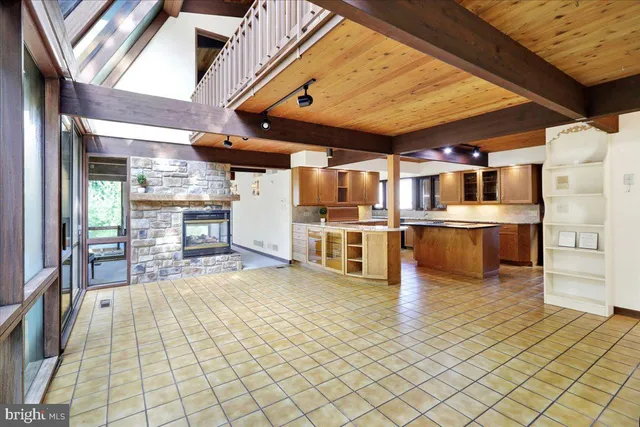 a view of a kitchen with stainless steel appliances wooden floor and chandelier