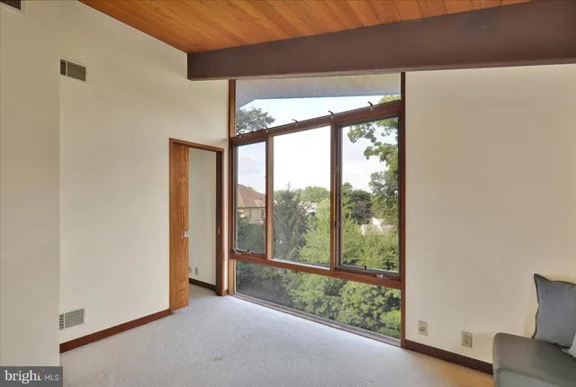 a view of a livingroom with a fireplace and a window