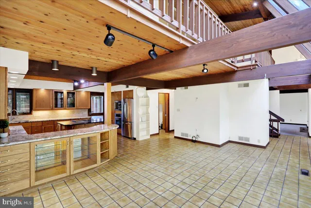 a kitchen with stainless steel appliances granite countertop sink stove and cabinets