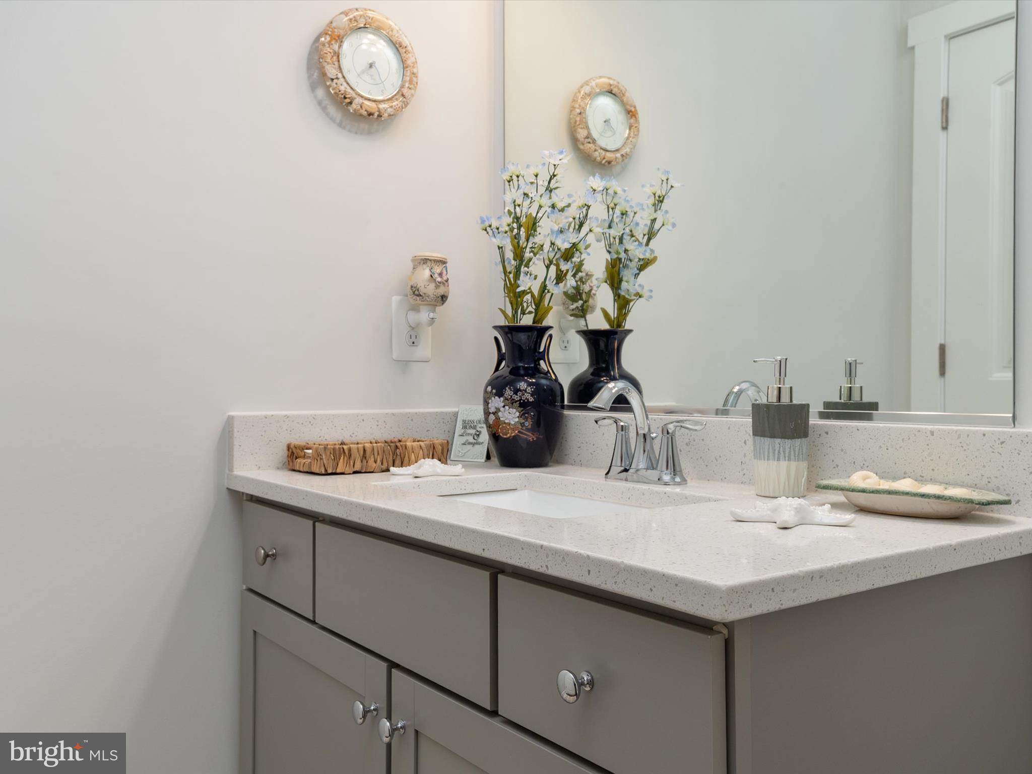 1000 Herons Nest Way, Unit 22 Chester, MD 21619 - Photo 11 of 59 a bathroom with a sink and a mirror