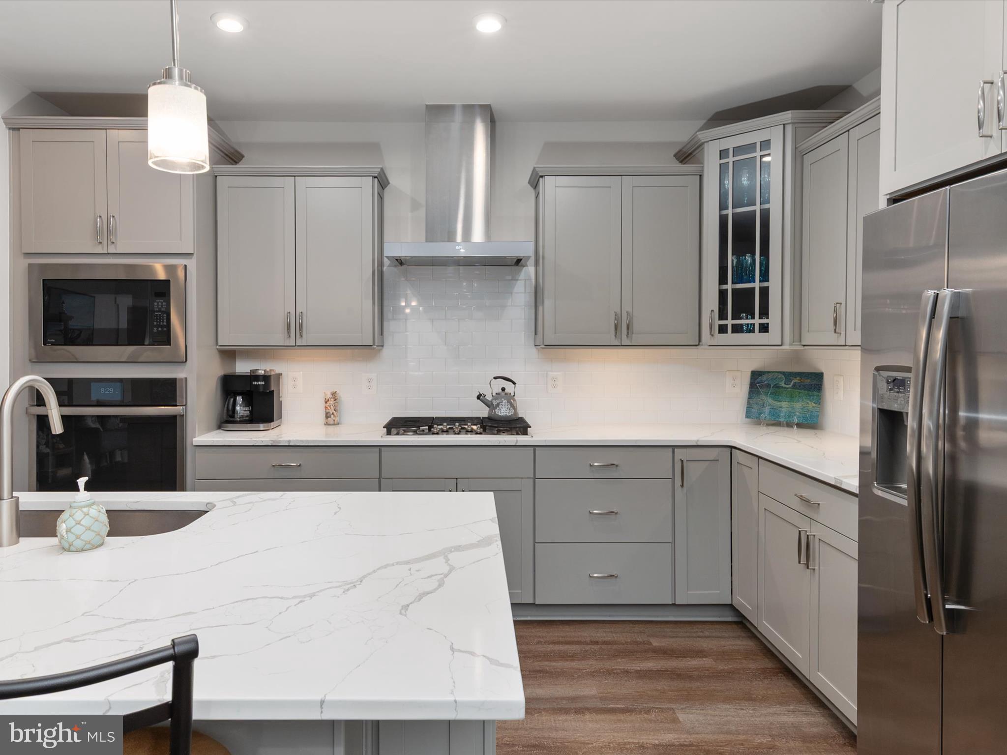 1000 Herons Nest Way, Unit 22 Chester, MD 21619 - Photo 14 of 59 a kitchen with a refrigerator a stove a sink and white cabinets
