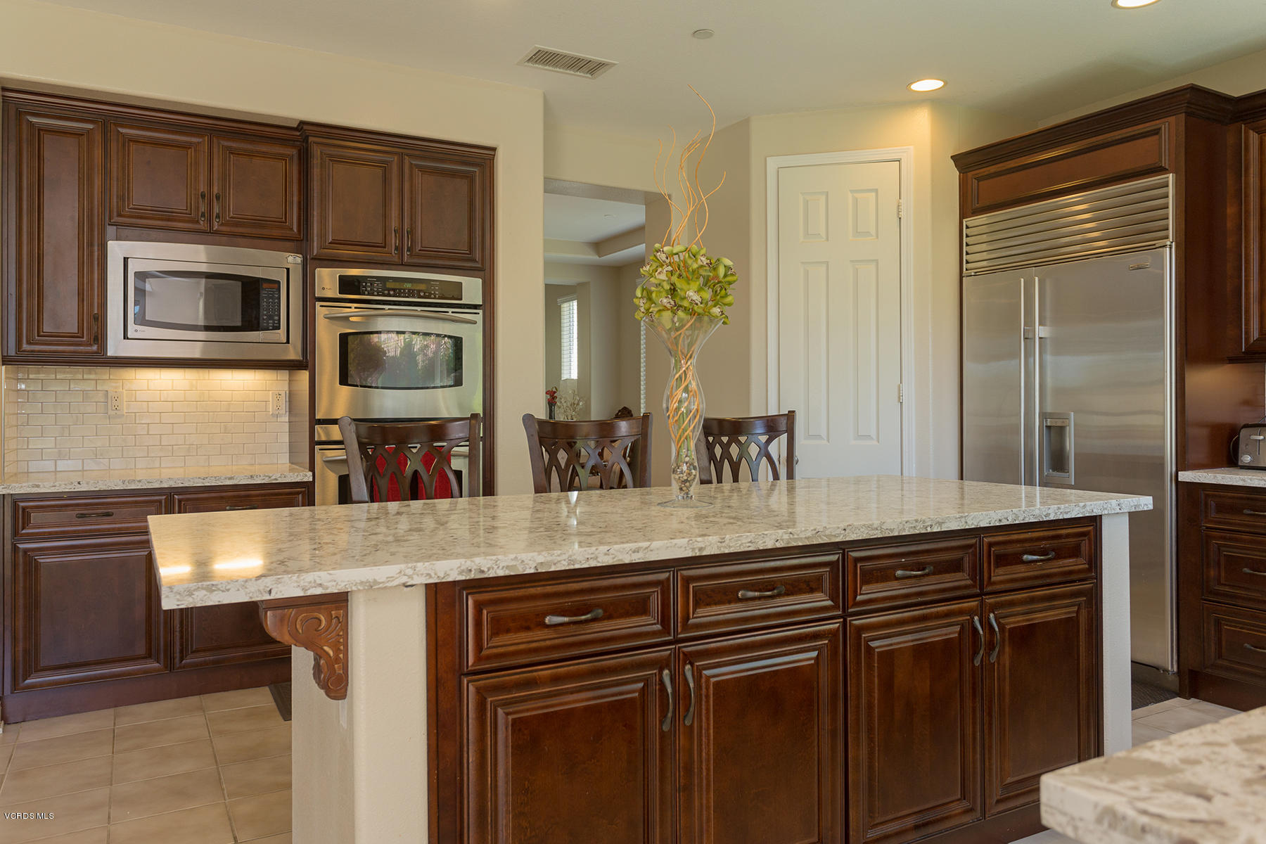 1397 Hidden Ranch Drive Simi Valley, CA 93063 - Photo 14 of 43 a kitchen with stainless steel appliances granite countertop a sink and a refrigerator