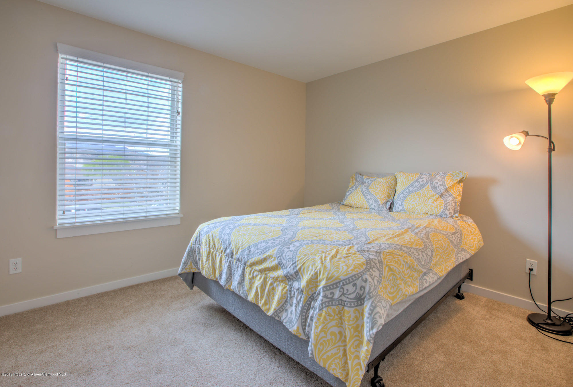 779 East 17th Street Rifle, CO 81650 - Photo 15 of 21 a bed sitting in a bedroom next to a window