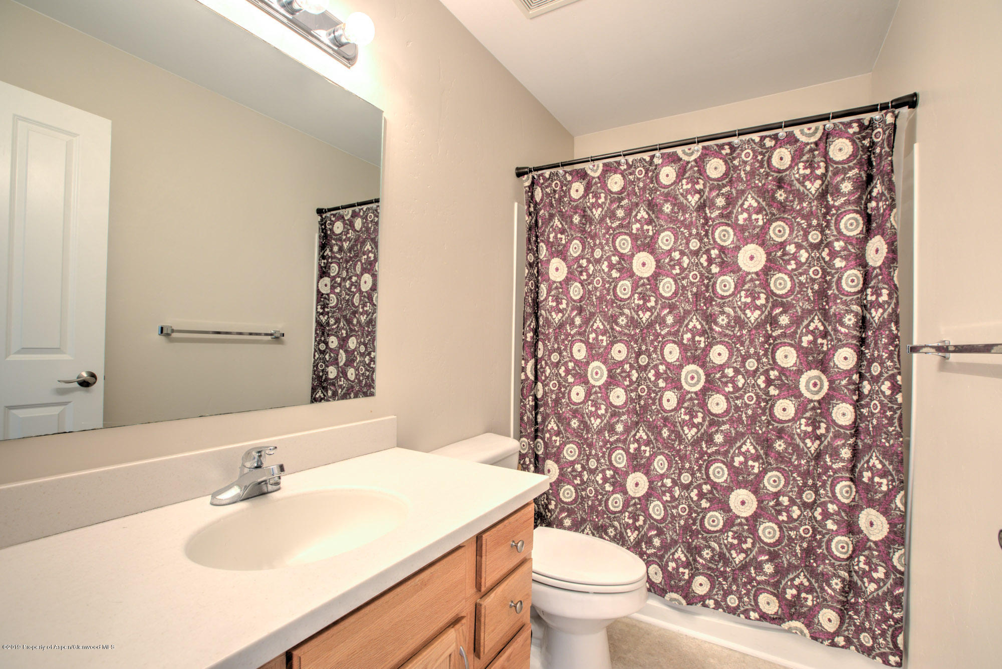 779 East 17th Street Rifle, CO 81650 - Photo 16 of 21 a bathroom with a sink toilet and mirror