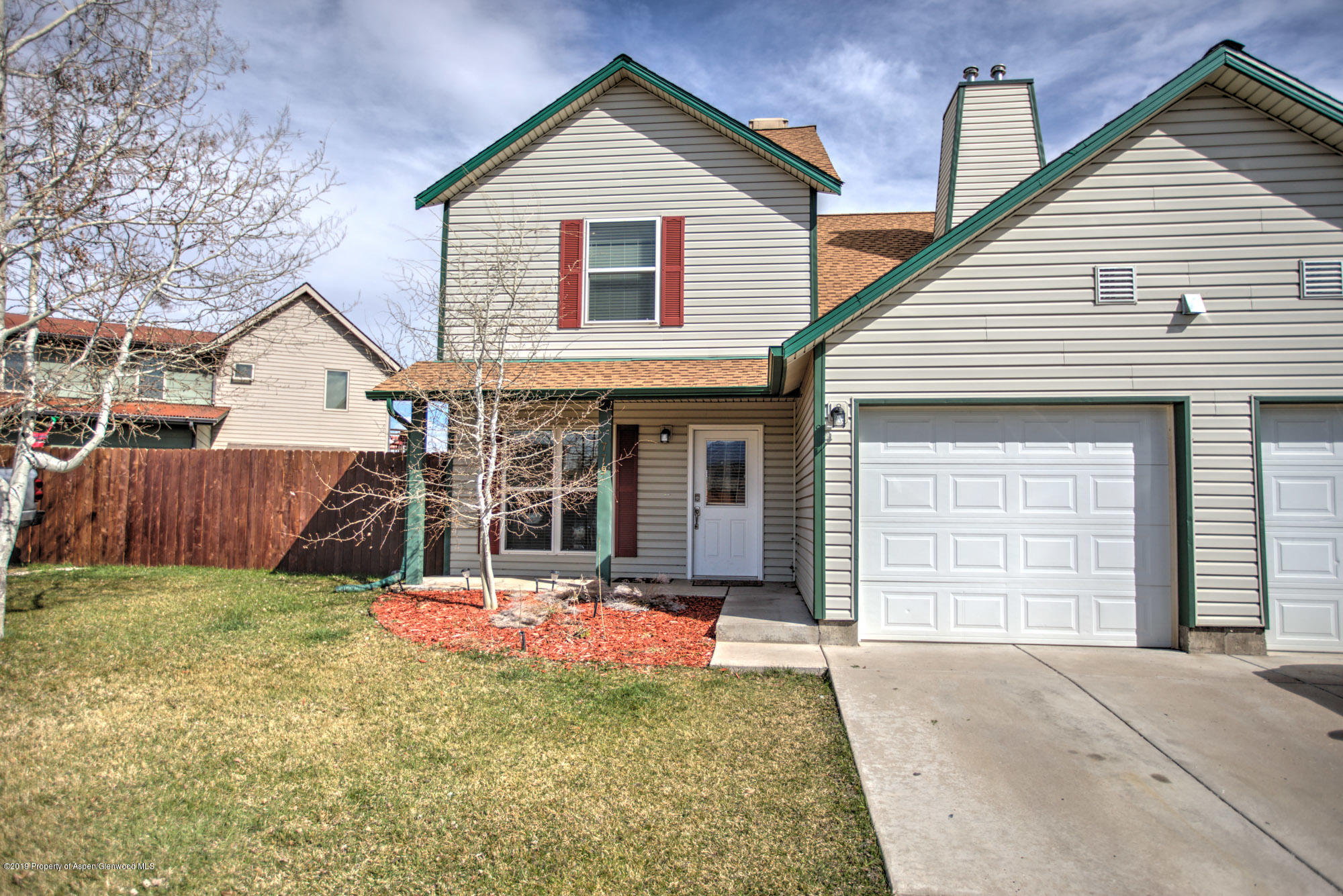 779 East 17th Street Rifle, CO 81650 - Photo 2 of 21 a front view of a house with a yard and garage
