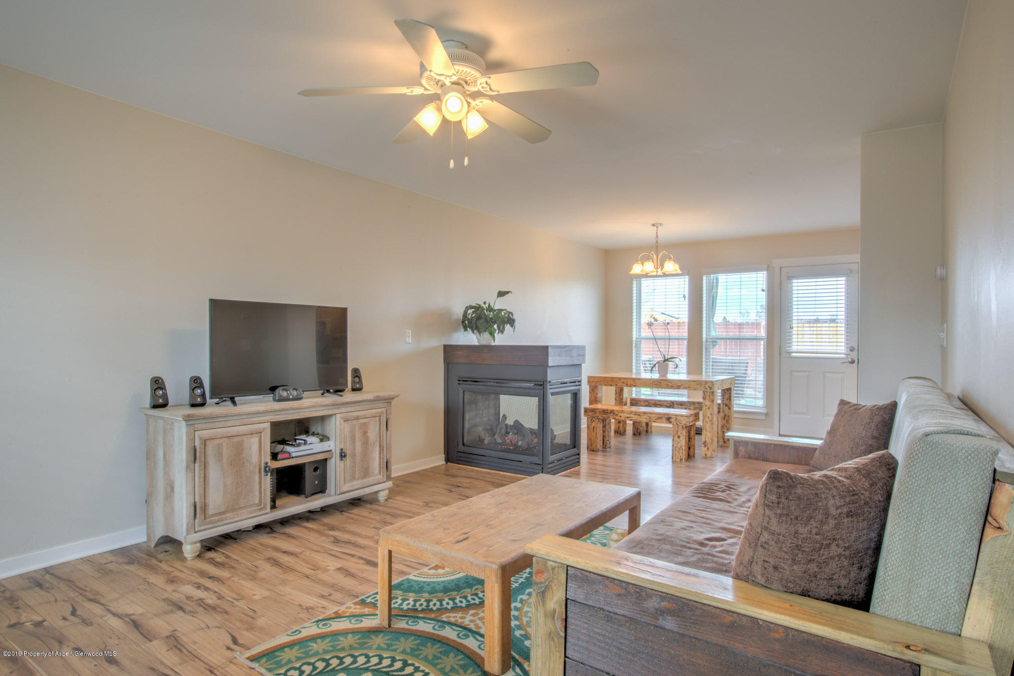 779 East 17th Street Rifle, CO 81650 - Photo 5 of 21 a living room with furniture a fireplace and a flat screen tv