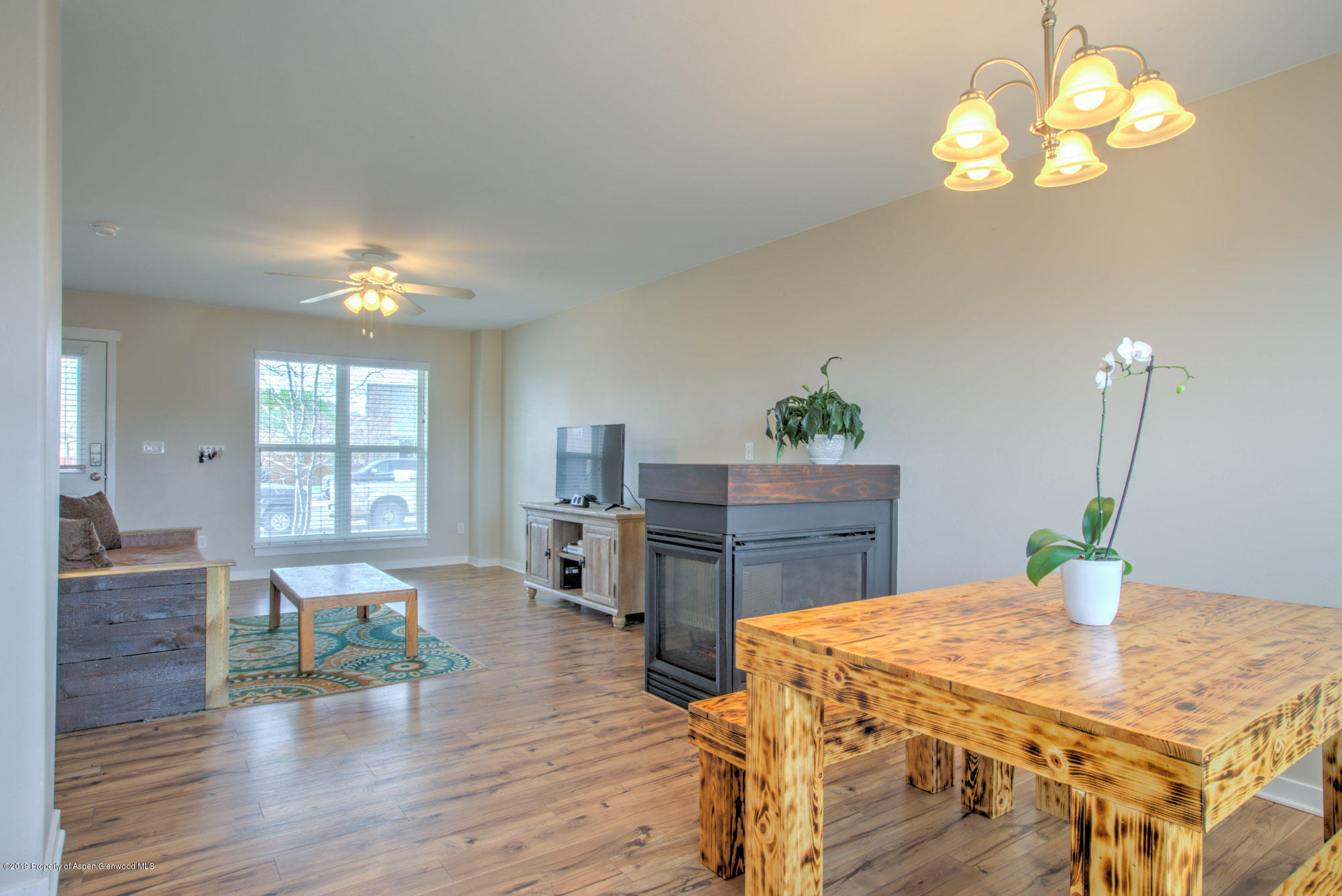 779 East 17th Street Rifle, CO 81650 - Photo 6 of 21 a living room with fireplace furniture and a chandelier