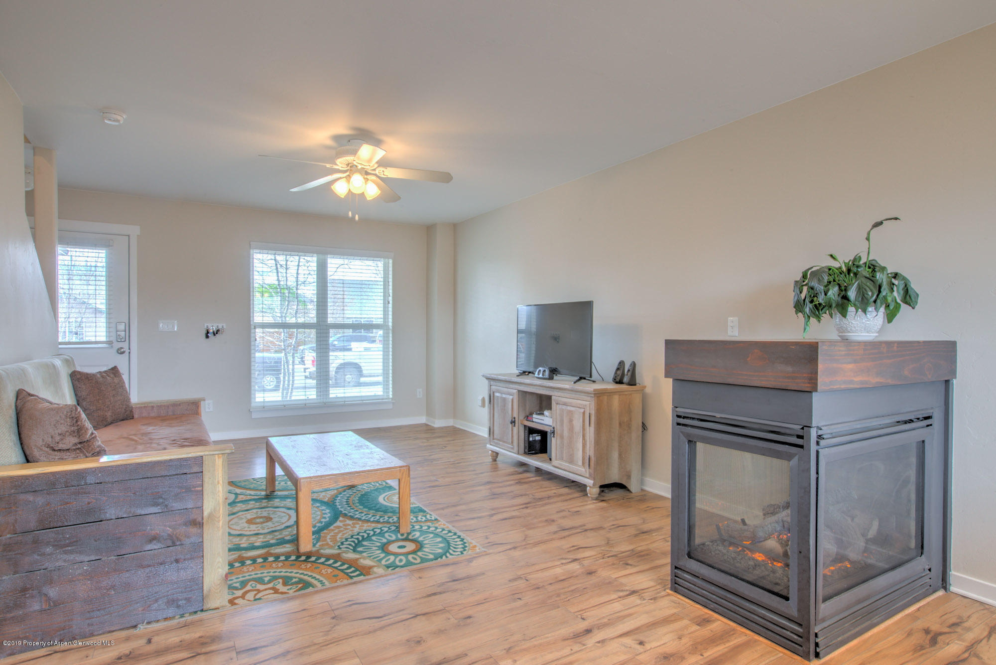 779 East 17th Street Rifle, CO 81650 - Photo 7 of 21 a living room with furniture and a chandelier