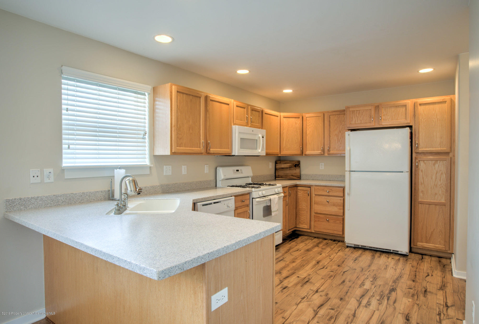 779 East 17th Street Rifle, CO 81650 - Photo 8 of 21 a kitchen with a refrigerator a sink and a microwave
