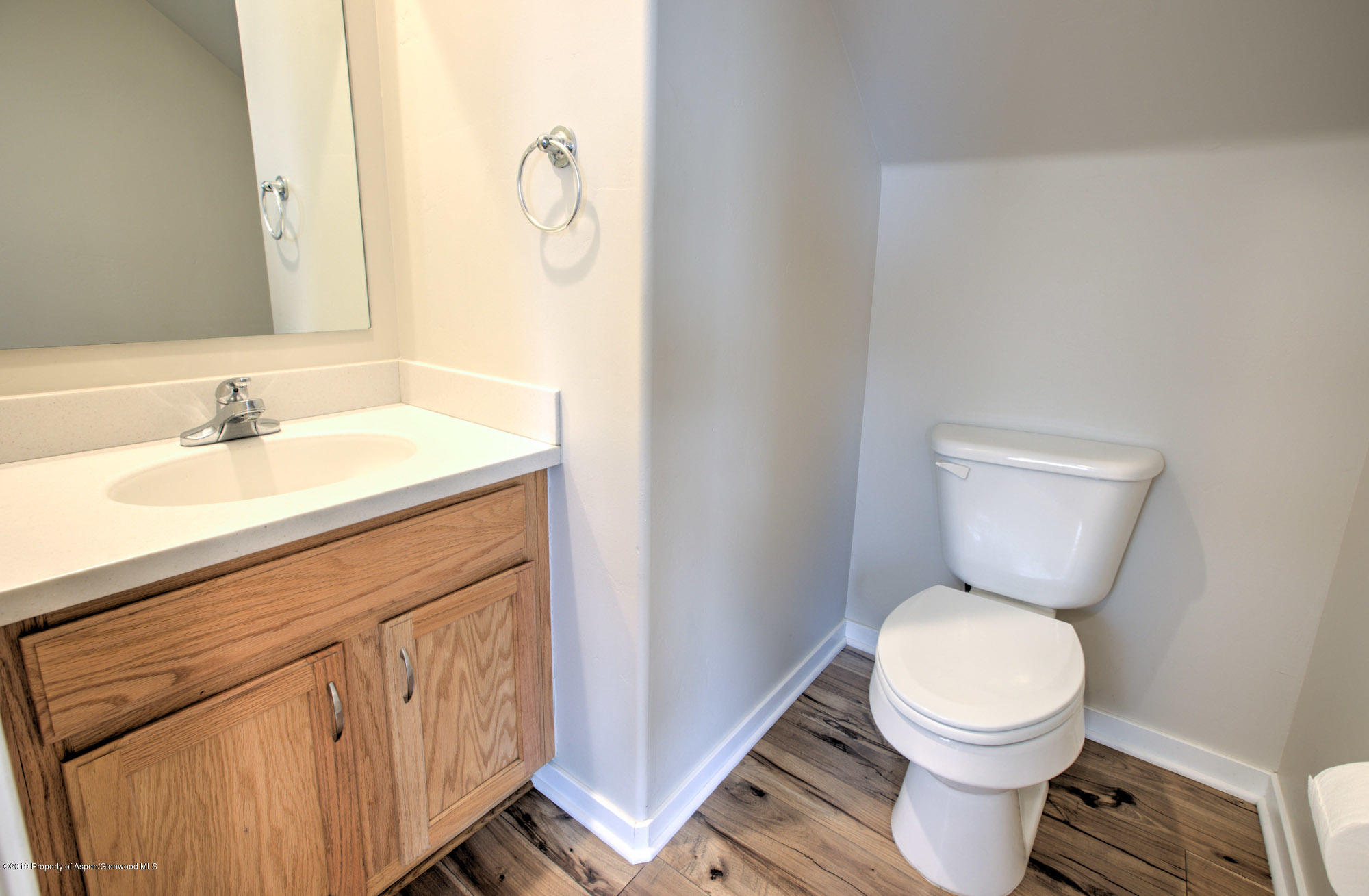 779 East 17th Street Rifle, CO 81650 - Photo 10 of 21 a bathroom with a granite countertop toilet sink and mirror