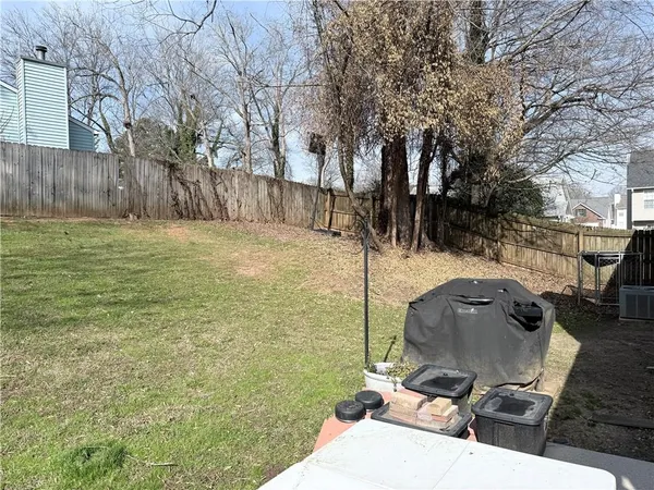a view of a backyard with wooden fence