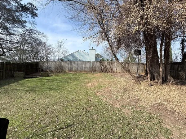 a view of a backyard with large trees