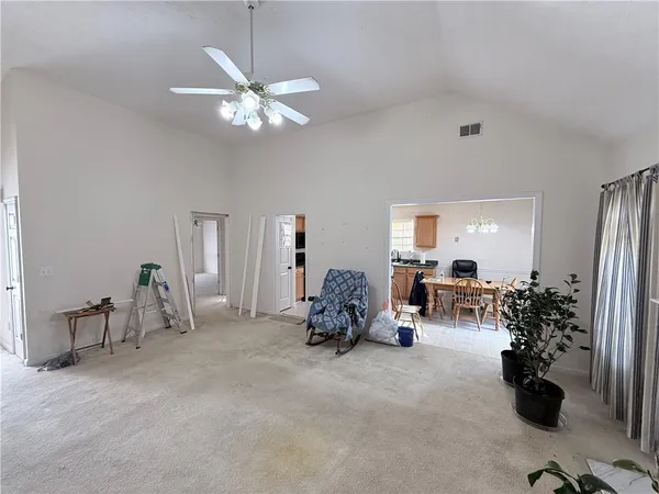a view of a livingroom with furniture and a ceiling fan