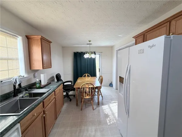 a kitchen with a refrigerator and a sink