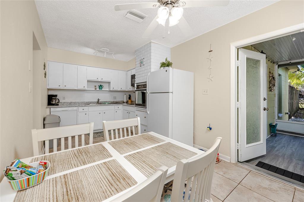 5596 100th Way North St. Petersburg, FL 33708 - Photo 53 of 67 a open kitchen with stainless steel appliances granite countertop a refrigerator and a stove