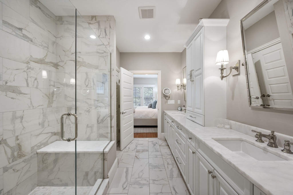 10 Backriver Road, Unit 10 Hingham, MA 02043 - Photo 14 of 31 a bathroom with a double vanity sink a toilet and shower