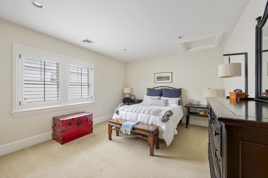 10 Backriver Road, Unit 10 Hingham, MA 02043 - Photo 19 of 31 a bed room with a bed and a chair