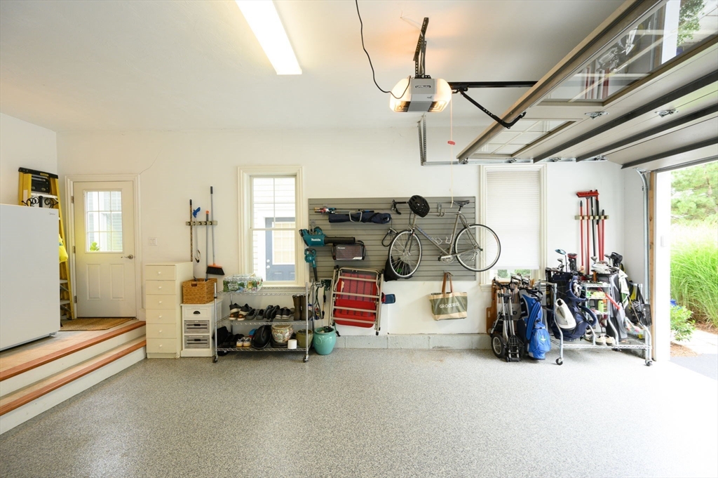 10 Backriver Road, Unit 10 Hingham, MA 02043 - Photo 25 of 31 a garage with furniture and a chandelier