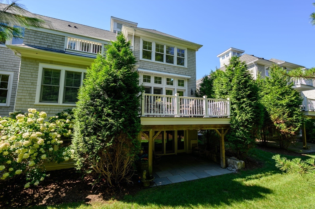 10 Backriver Road, Unit 10 Hingham, MA 02043 - Photo 27 of 31 a view of a chair and table in the patio next to a house