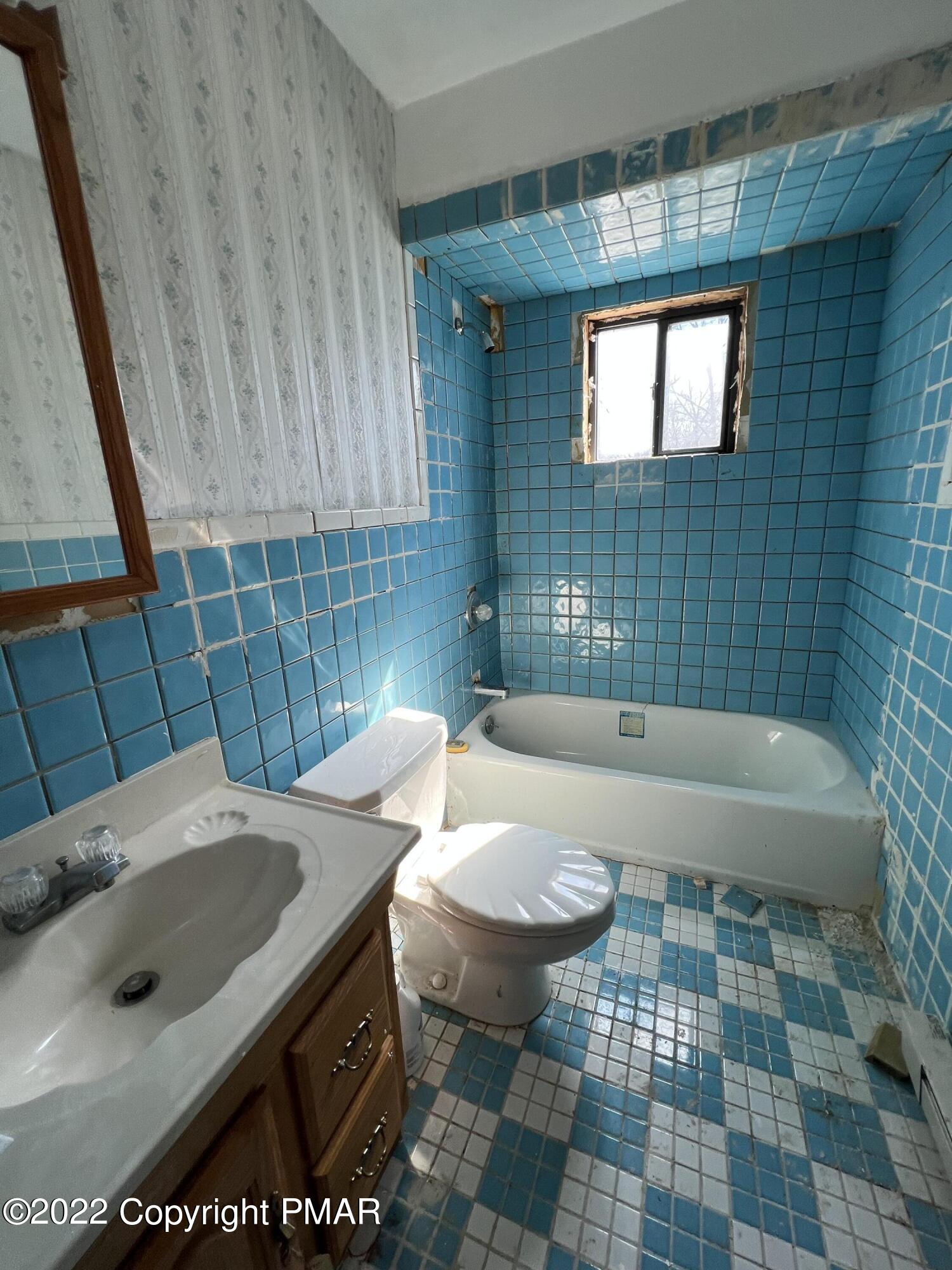 152 Caribou Road Dingmans Ferry, PA 18328 - Photo 13 of 15 a bathroom with a sink a toilet and shower