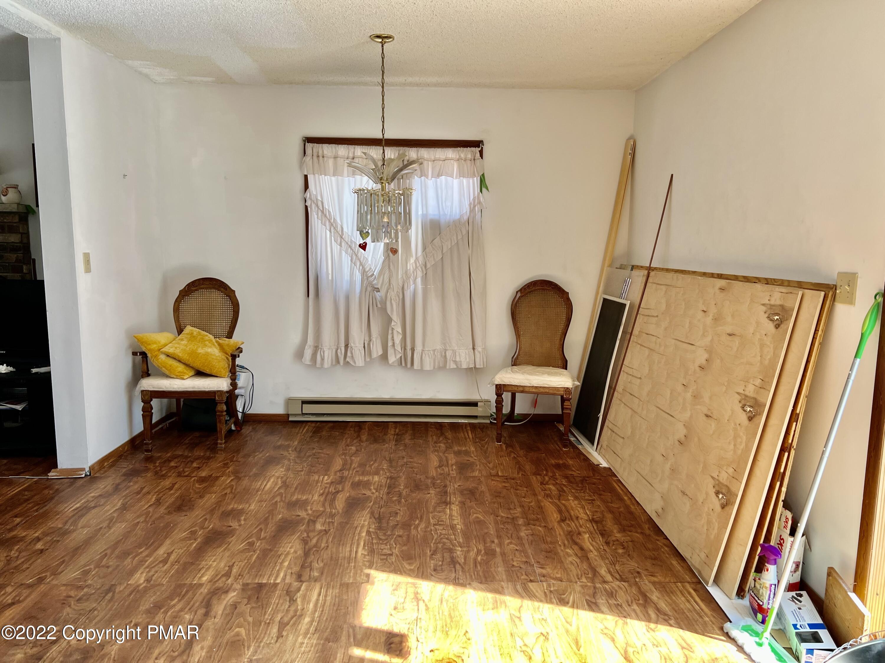 152 Caribou Road Dingmans Ferry, PA 18328 - Photo 6 of 15 a view of a room with furniture and wooden floor