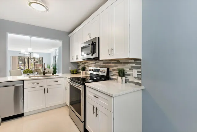 a kitchen with a sink stove and cabinets