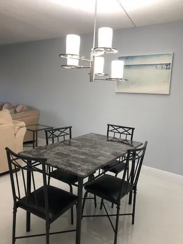 a view of a dining room with furniture and chandelier
