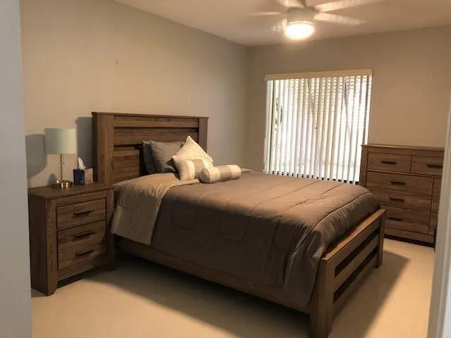 a bedroom with a bed and a window
