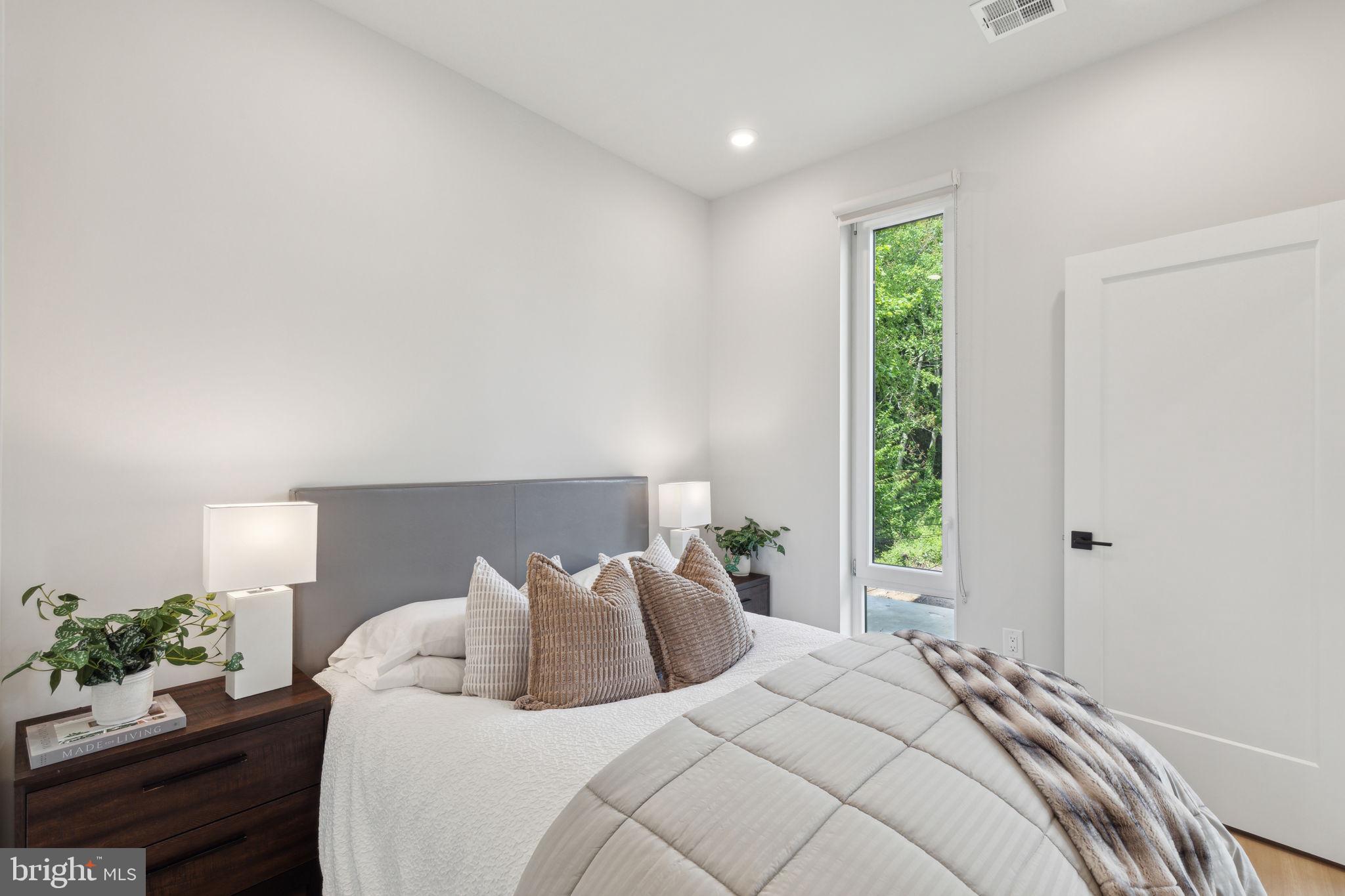 6910 Ridge Avenue, Unit 418 Philadelphia, PA 19128 - Photo 11 of 26 a bedroom with a bed and a window