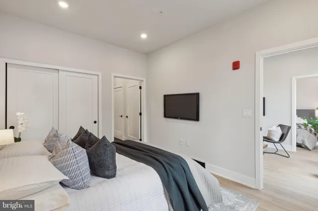 a bedroom with a bed and a flat screen tv