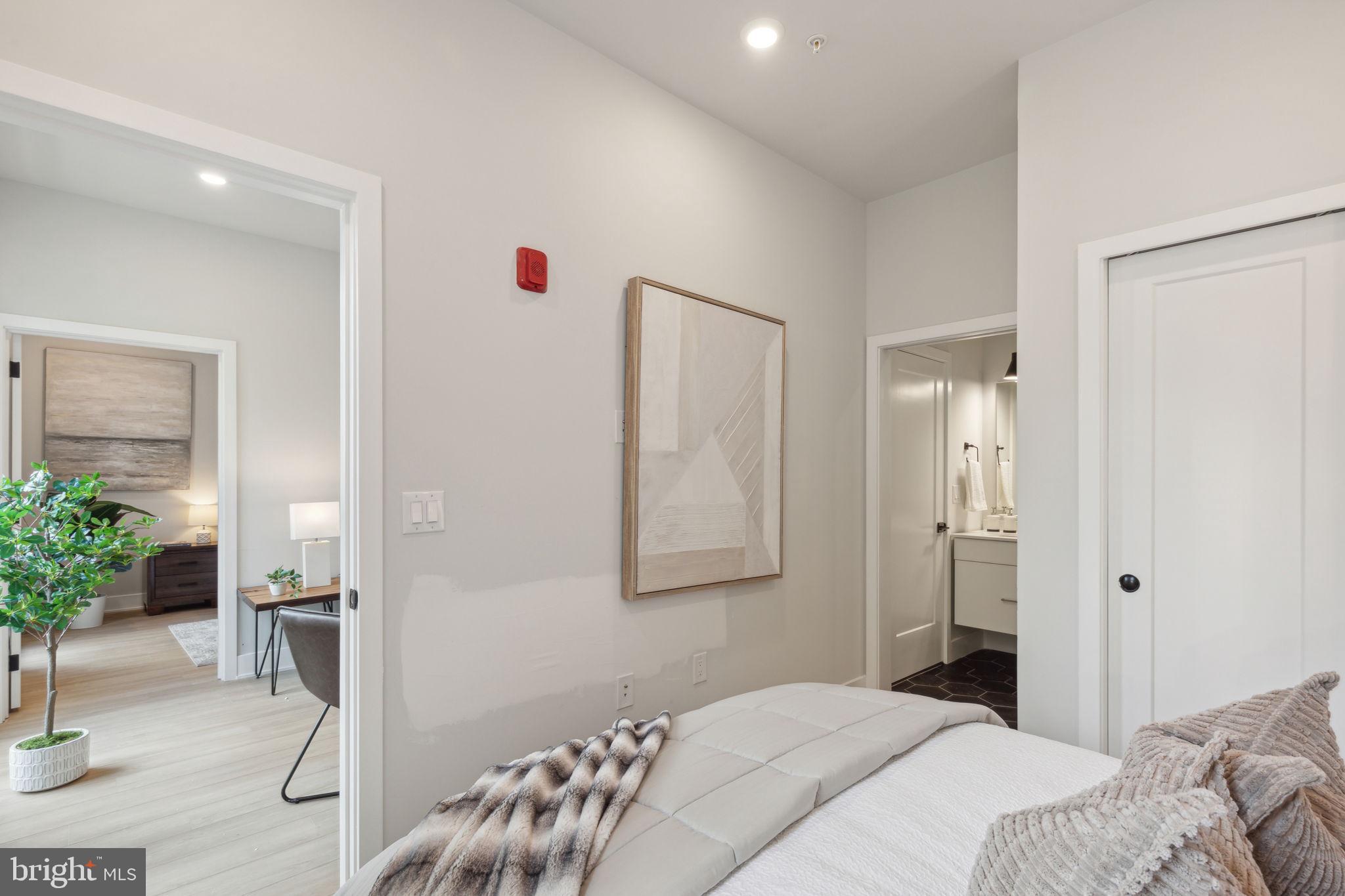 6910 Ridge Avenue, Unit 418 Philadelphia, PA 19128 - Photo 16 of 26 a bedroom with a bed and a potted plant